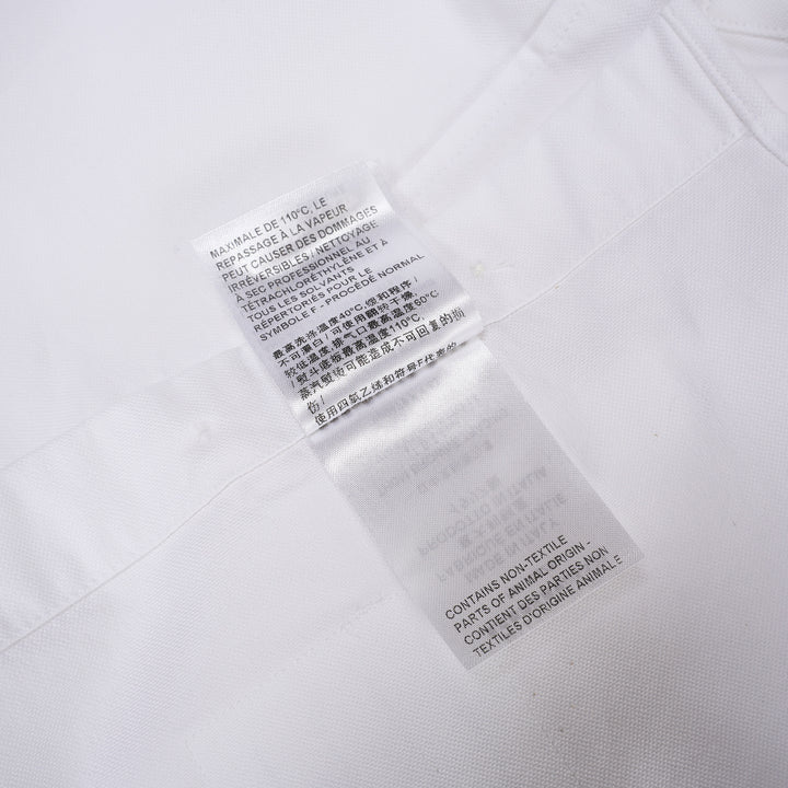 Thom Browne white oxford long sleeve shirt with rounded collar, button-front placket, single chest pocket, and signature four-bar grey stripe across one sleeve - view 5
