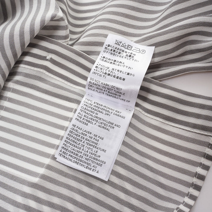 Thom Browne grey and white vertical stripe long sleeve blouse with detachable pussy-bow collar, contrast horizontal-stripe cuffs, and signature woven label patch at the hip - view 4
