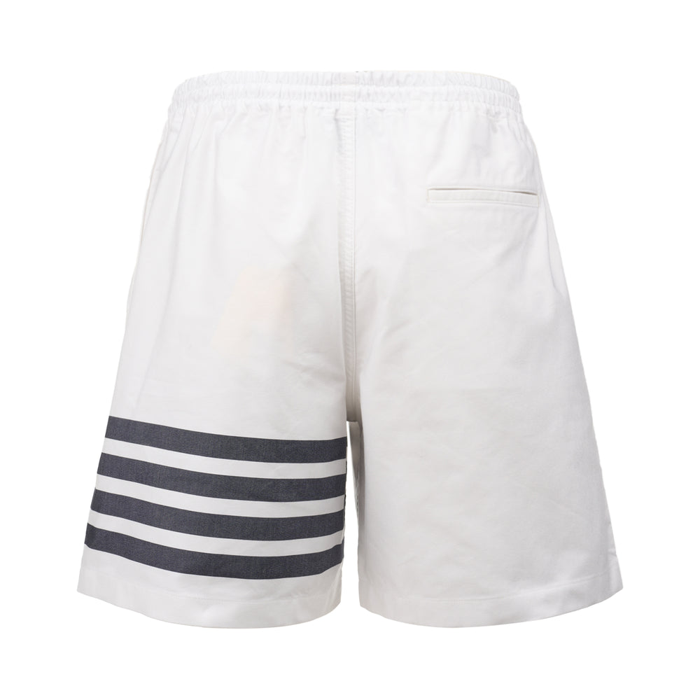 Thom Browne white rugby shorts with elastic drawstring waist and signature four-bar navy stripe across one leg, 8-inch inseam - view 2