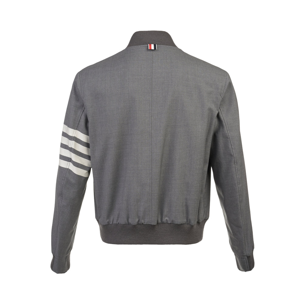 Thom Browne medium grey wool blouson jacket with four-bar cream stripe on the sleeve, ribbed knit collar, cuffs and hem, centre-front zip, and two snap-button hip pockets - view 2
