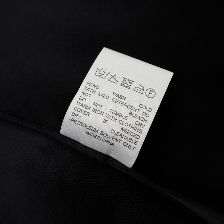Black matte satin long-sleeve blouse with crew neckline and wide cuffs, shown flat from the front - view 4