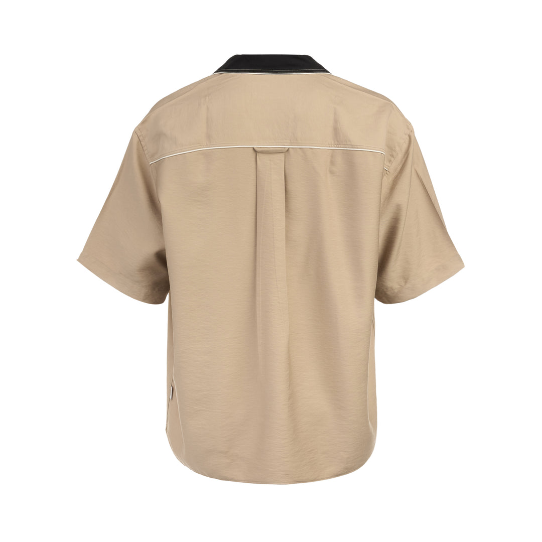 AMI Alexandre Mattiussi Shark Collar Boxy Short Sleeve Shirt in tan and black with contrast cream piping and button-through front, flat lay on white background - view 2