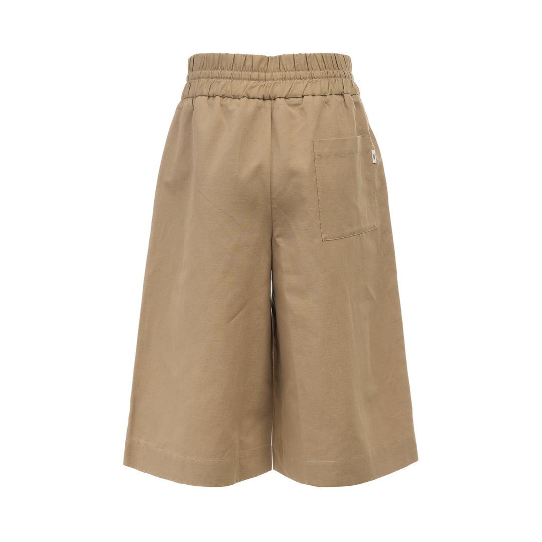 AMI Elasticated Large Bermuda Shorts in khaki tan, featuring a wide-leg silhouette, elasticated paper-bag waistband with drawstring, and hem side slits, displayed flat on a white background - view 2