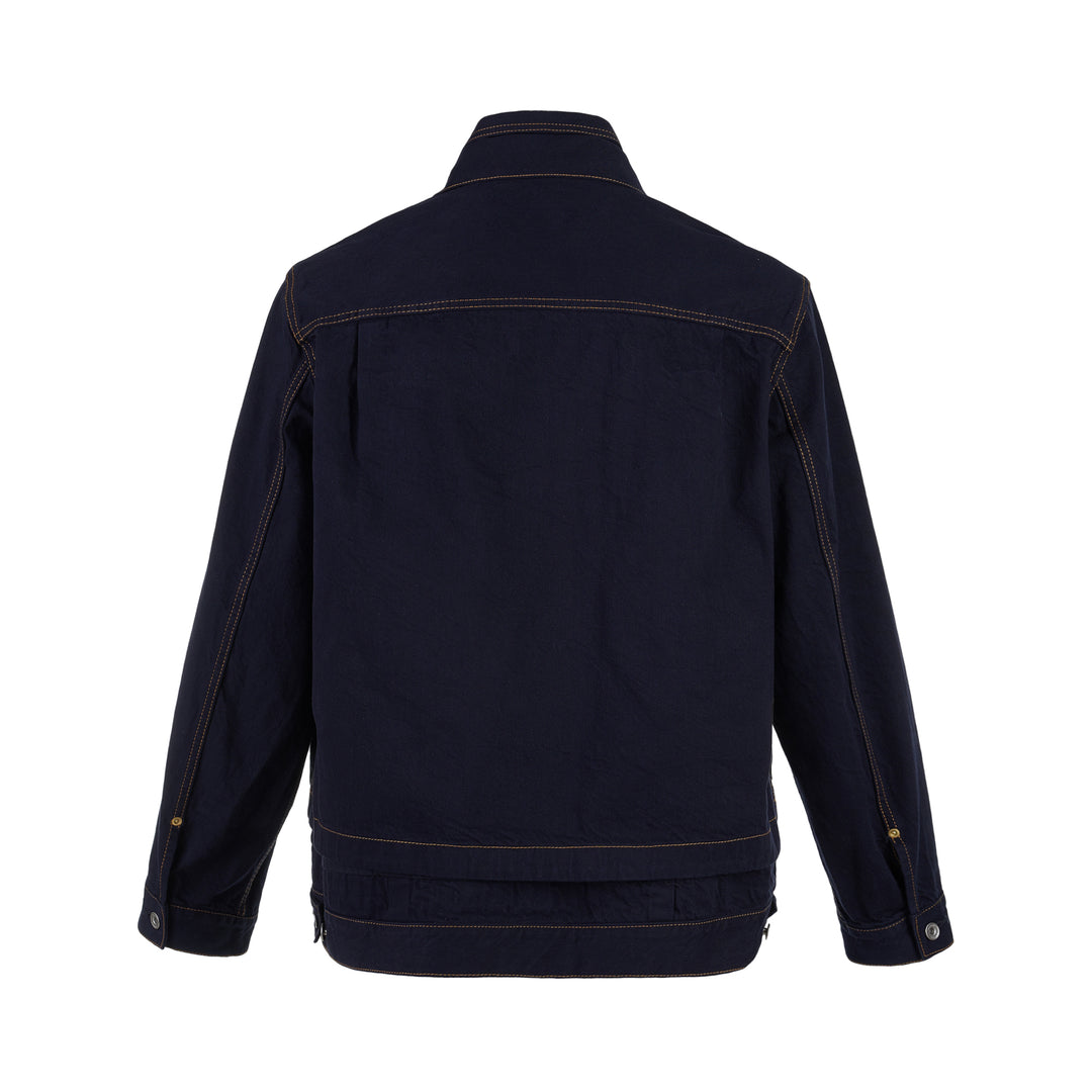 sacai indigo denim trucker jacket with contrast topstitching, pleated front panels, button-flap chest pockets and a layered hem, shown from the front - view 2