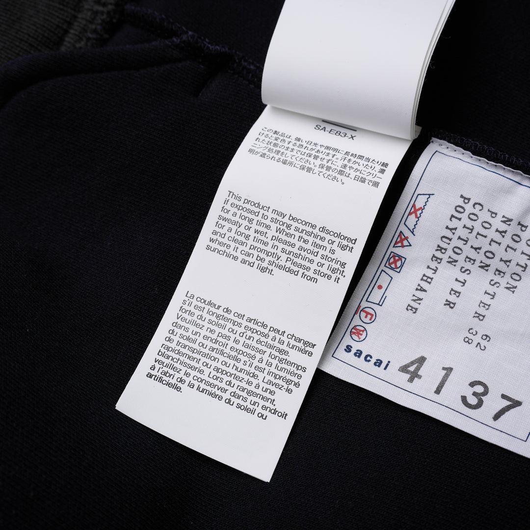 sacai Sponge Sweat Blouson in navy with asymmetric diagonal zip, contrast dark ribbed hem and cuffs, chest snap tabs and off-white sleeve zip pocket - view 8