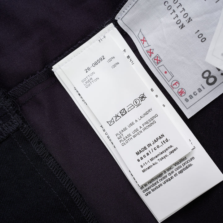 sacai belted peplum denim midi skirt in dark indigo with contrast topstitching, shown from the front - view 3