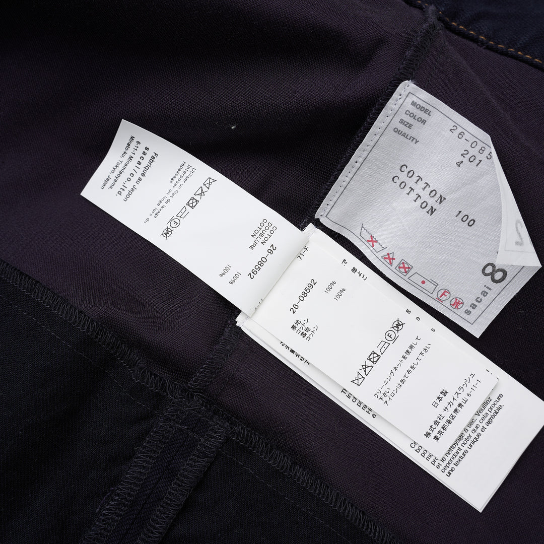 sacai belted peplum denim midi skirt in dark indigo with contrast topstitching, shown from the front - view 4