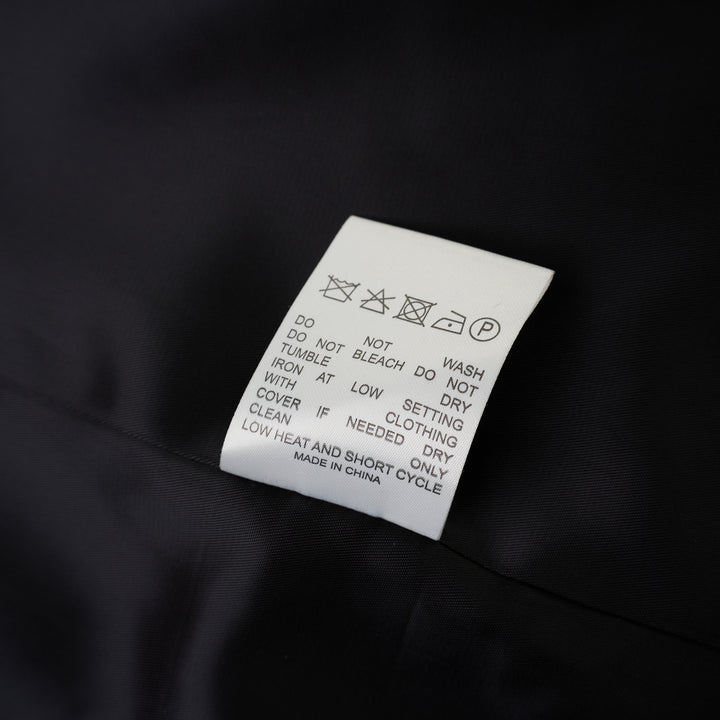 Black collarless wool-blend blazer with deep V neckline, single button closure and welt chest pocket, shown against a white background - view 4