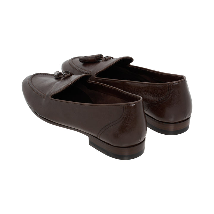 The Row Caden loafer in brown grained leather with leather tassel, moccasin stitching and low stacked heel, side view - view 3