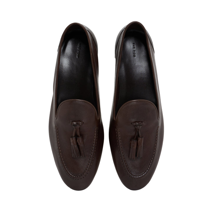 The Row Caden loafer in brown grained leather with leather tassel, moccasin stitching and low stacked heel, side view - view 4