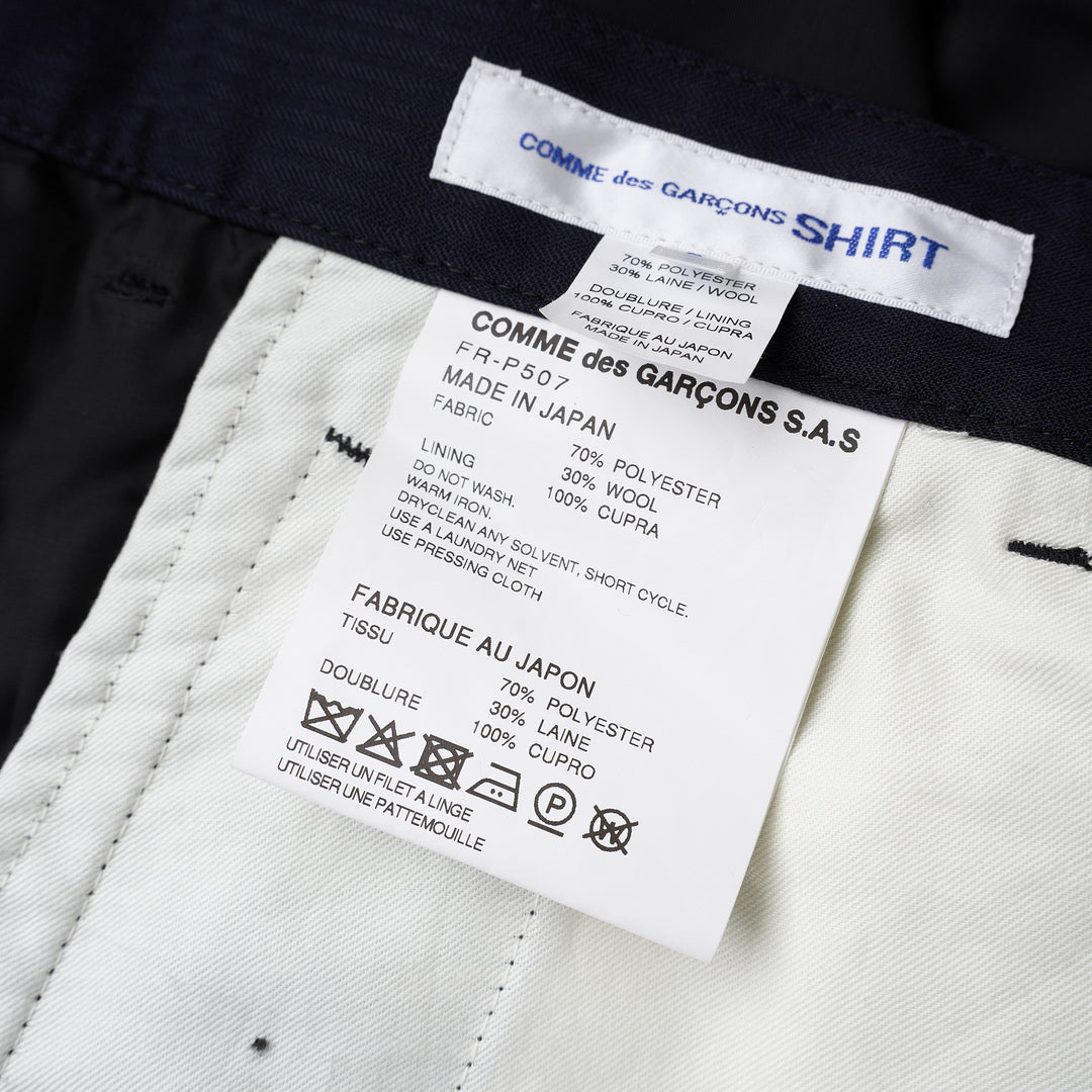 Comme des Garçons Shirt dark navy striped drop-crotch cargo pants with flap side pockets and cropped legs, shown from the front - view 3