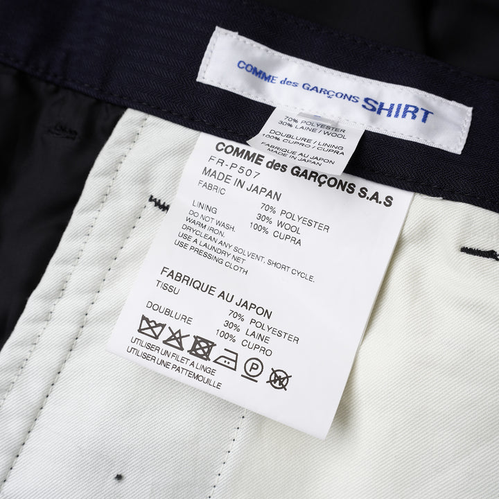 Comme des Garçons Shirt dark navy striped drop-crotch cargo pants with flap side pockets and cropped legs, shown from the front - view 3