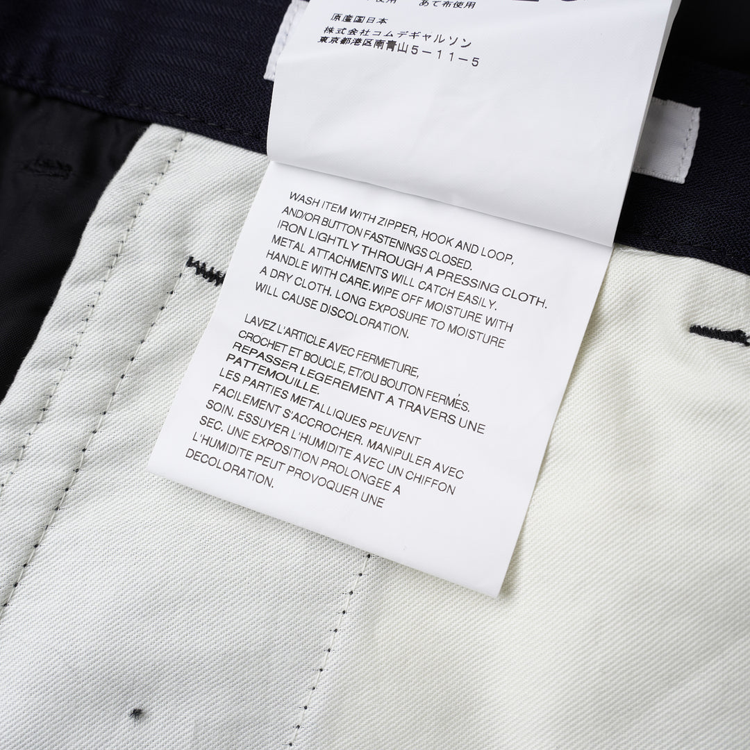 Comme des Garçons Shirt dark navy striped drop-crotch cargo pants with flap side pockets and cropped legs, shown from the front - view 4