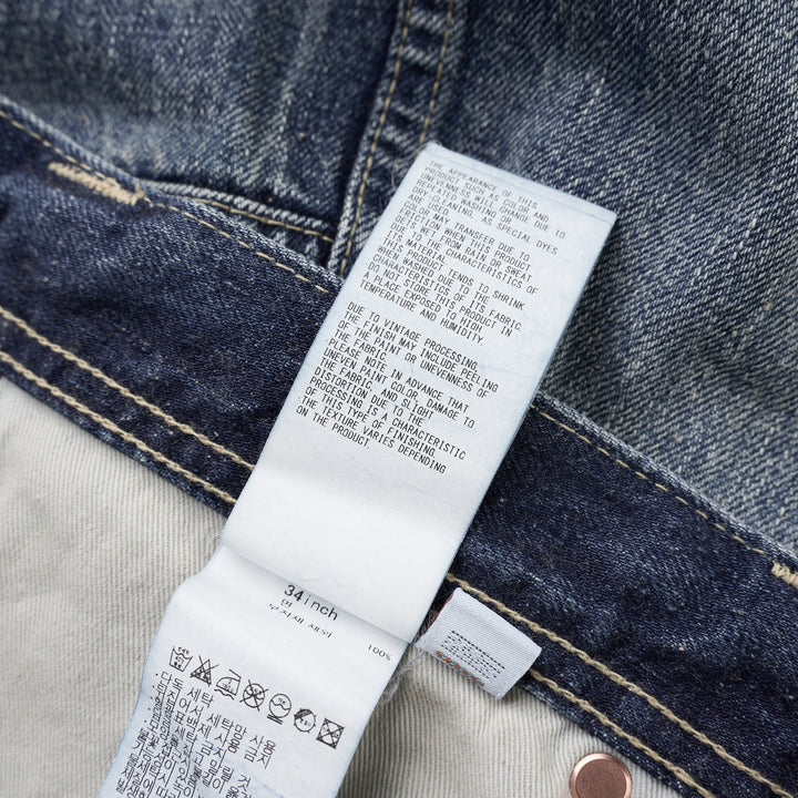 Human Made slim denim pants in a washed mid-indigo finish, shown front-facing with button fly and contrast topstitching - view 3