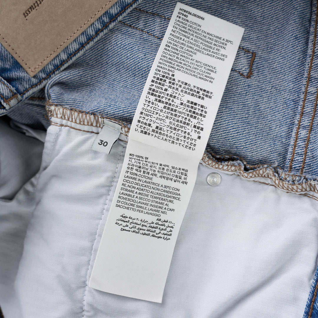 AMI large fit jeans in light washed blue denim with a wide straight leg, five-pocket design and button fly, shown front view - view 4