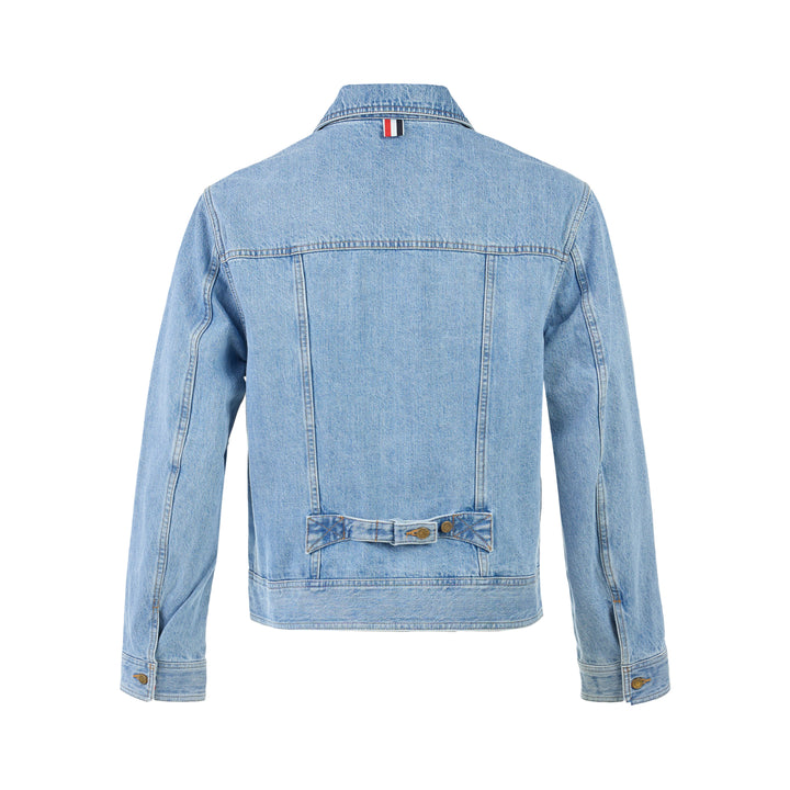Thom Browne Backstrap Utility Jacket in light-wash denim with twin chest flap pockets and brass buttons, shown from the front - view 2