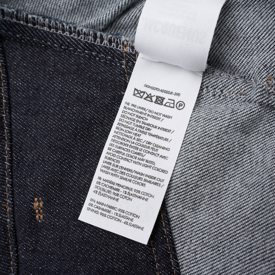 Jacquemus La Jupe Cubisto dark indigo denim midi skirt with contrast topstitching, high waist, and curved sculptural silhouette, shown from the front - view 3