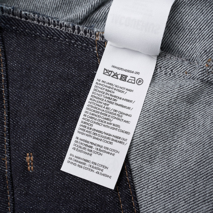 Jacquemus La Jupe Cubisto dark indigo denim midi skirt with contrast topstitching, high waist, and curved sculptural silhouette, shown from the front - view 3