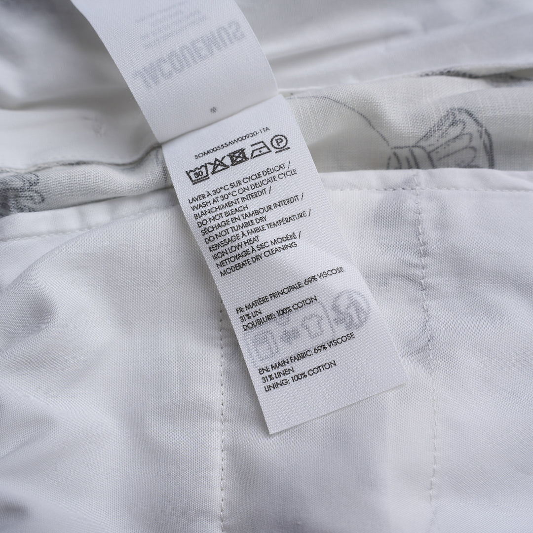 Jacquemus Le Boxer shorts in white with a black and grey illustrated print of shells, fish, grapes and champagne coupes, shown with a smocked high waistband - view 3