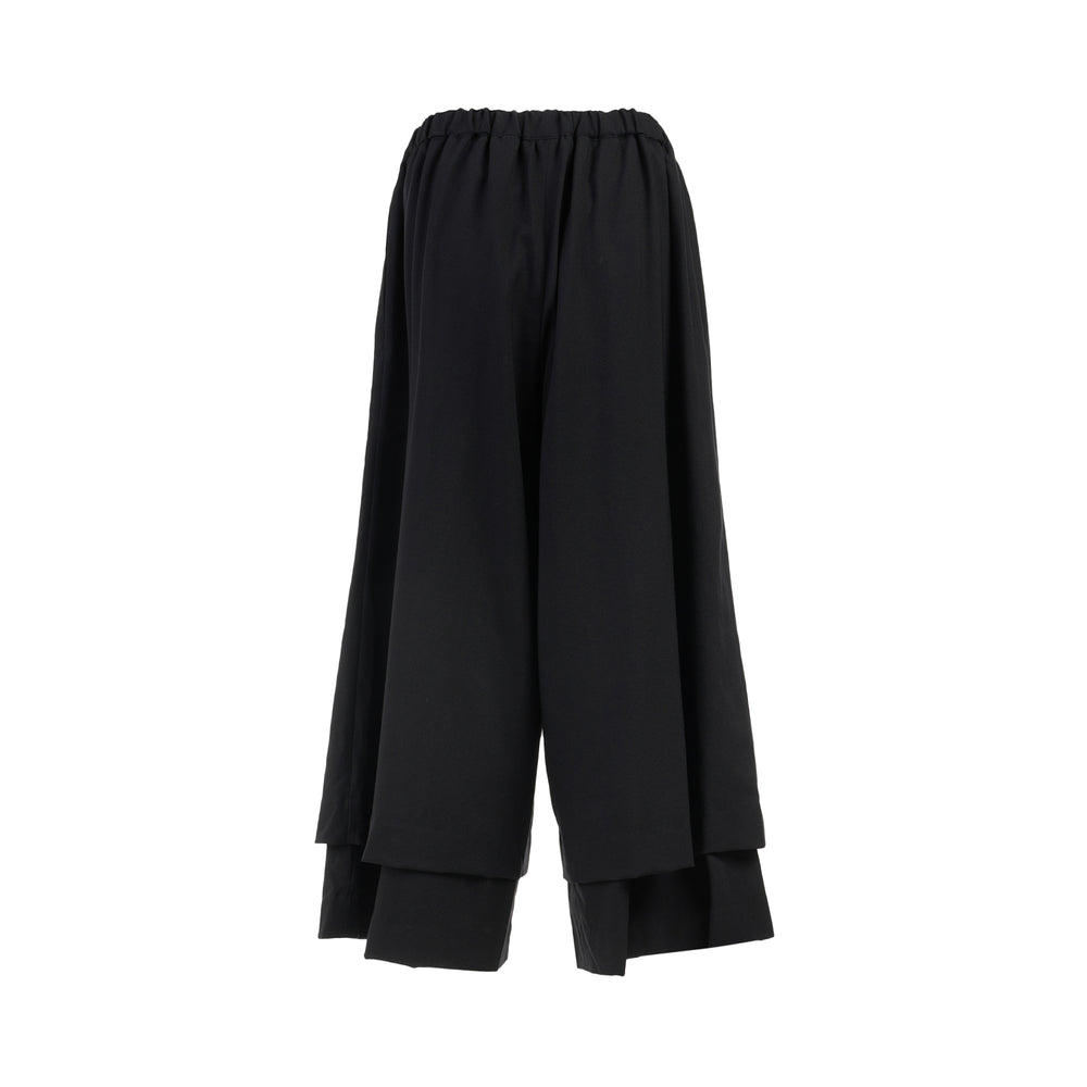 Comme des Garçons black wool georgette wide-leg pants with an elasticated waist and double-layered hem, shown from the front - view 2