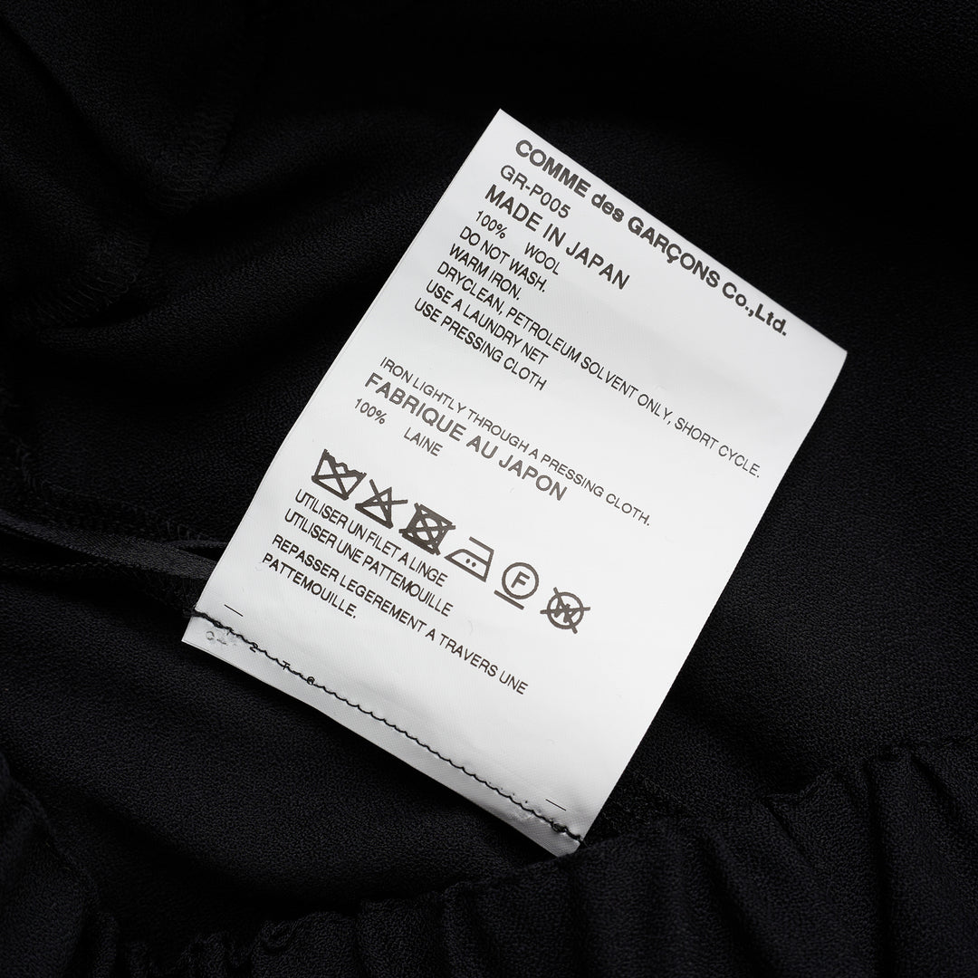 Comme des Garçons black wool georgette wide-leg pants with an elasticated waist and double-layered hem, shown from the front - view 3