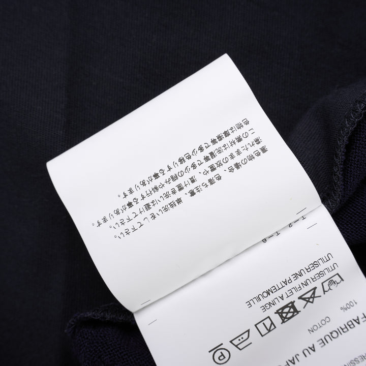 Comme des Garçons Homme navy fine-knit tee with contrasting black short sleeves, ribbed crew neck and hem, shown flat from the front - view 5
