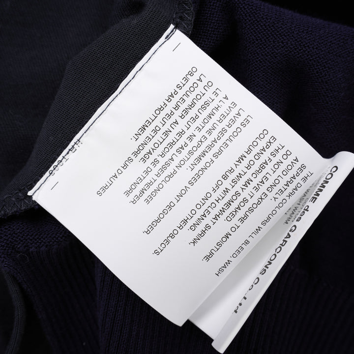 Comme des Garçons Homme navy fine-knit tee with contrasting black short sleeves, ribbed crew neck and hem, shown flat from the front - view 6