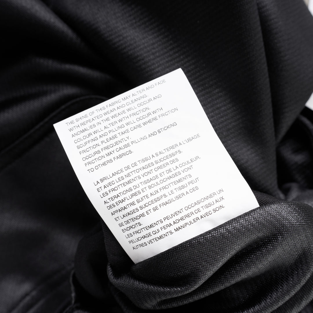 Comme des Garçons Homme Plus black gloss finish wide-leg flared pants with elasticated waistband, shown from the front - view 3