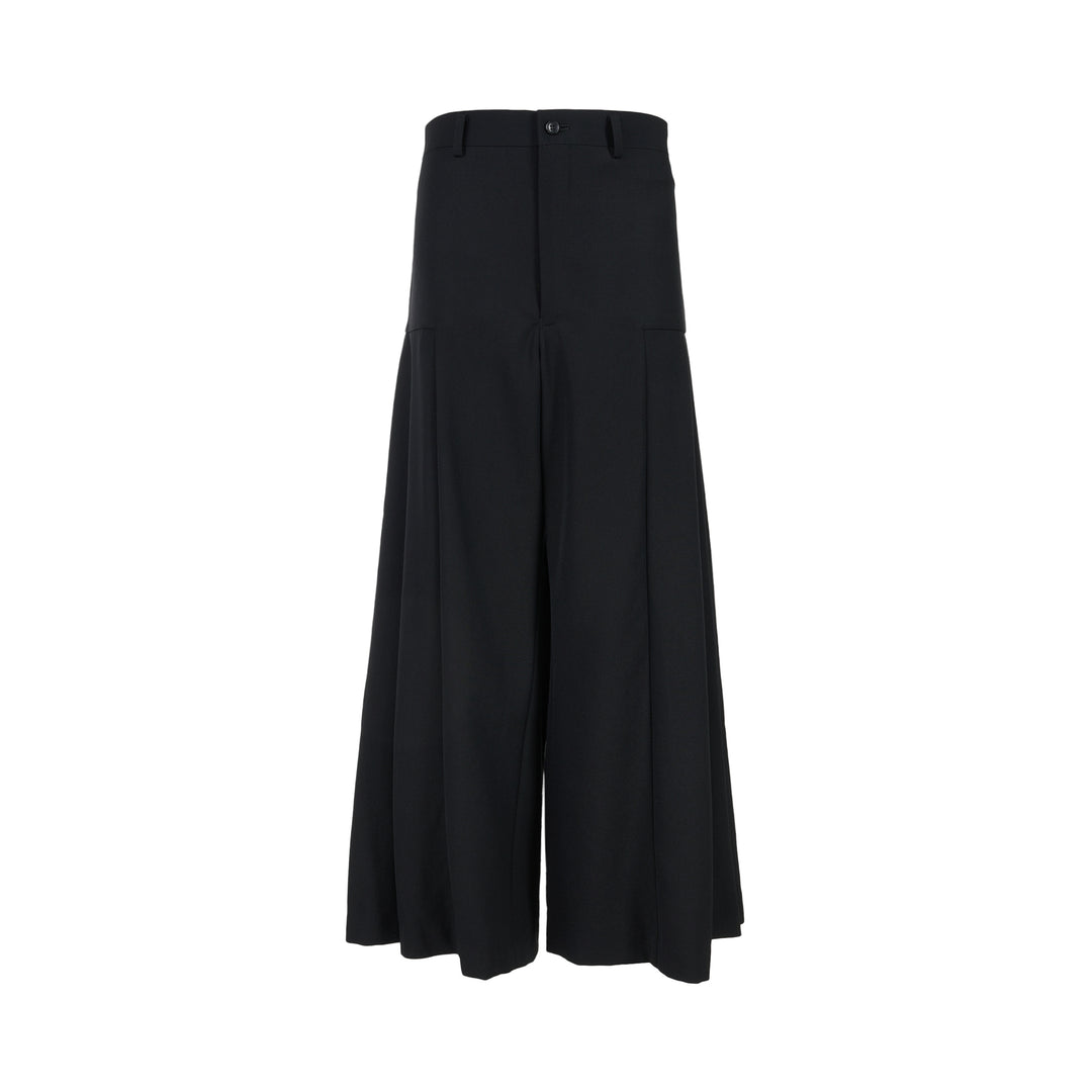 Black wool gabardine wide-leg pants with pleated skirt-like panels and high waist by Comme des Garçons Comme des Garçons