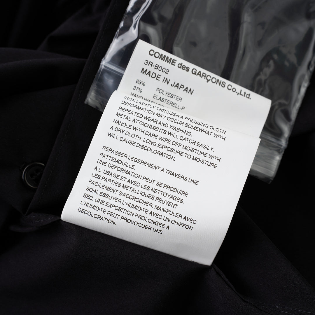 Noir Kei Ninomiya black button-up shirt with band collar, oversized bow with buckle straps across the chest and puffed elbow-length sleeves - view 4