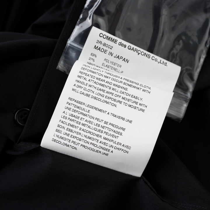 Noir Kei Ninomiya black button-up shirt with band collar, oversized bow with buckle straps across the chest and puffed elbow-length sleeves - view 4