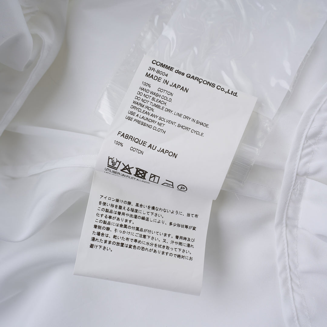 Noir Kei Ninomiya white cotton typewriter shirt with tiered pleated ruffle sleeves, pointed collar, button placket and curved flared hem - view 3