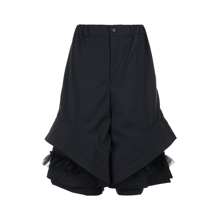 Noir Kei Ninomiya black wool tropical shorts with a stitched flared hem and layered black nylon tulle ruffles