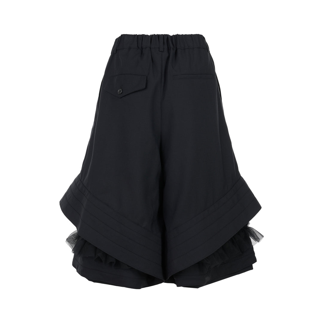 Noir Kei Ninomiya black wool tropical shorts with a stitched flared hem and layered black nylon tulle ruffles - view 2