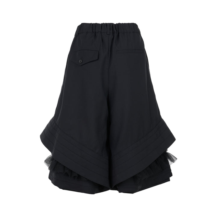 Noir Kei Ninomiya black wool tropical shorts with a stitched flared hem and layered black nylon tulle ruffles - view 2