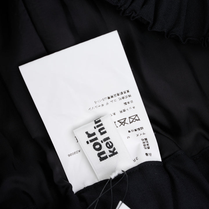 Noir Kei Ninomiya black wool tropical shorts with a stitched flared hem and layered black nylon tulle ruffles - view 3