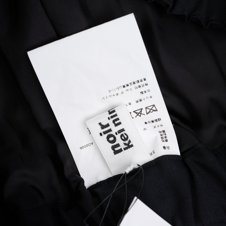 Noir Kei Ninomiya black wool tropical shorts with a stitched flared hem and layered black nylon tulle ruffles - view 4