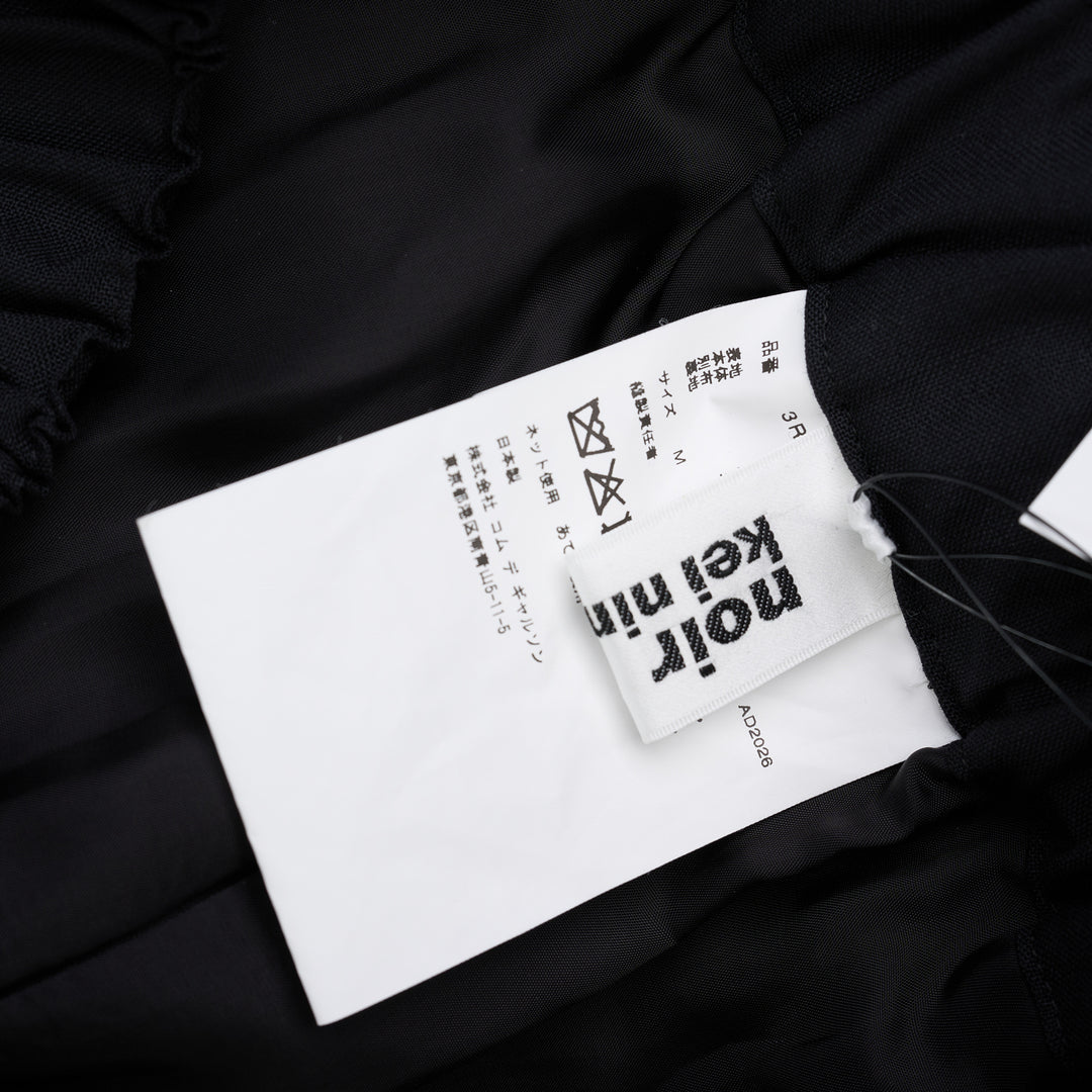 Noir Kei Ninomiya black wool tropical shorts with a stitched flared hem and layered black nylon tulle ruffles - view 5