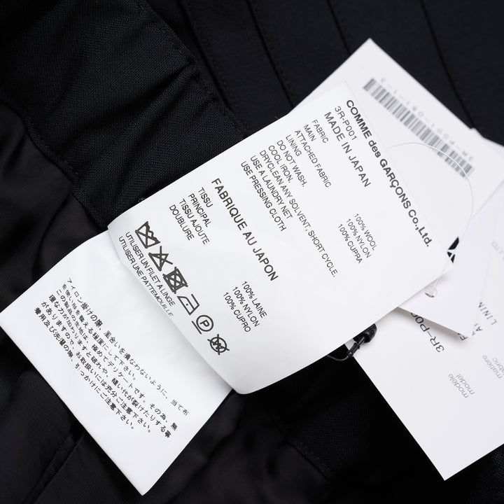 Noir Kei Ninomiya black wool tropical shorts with a stitched flared hem and layered black nylon tulle ruffles - view 7