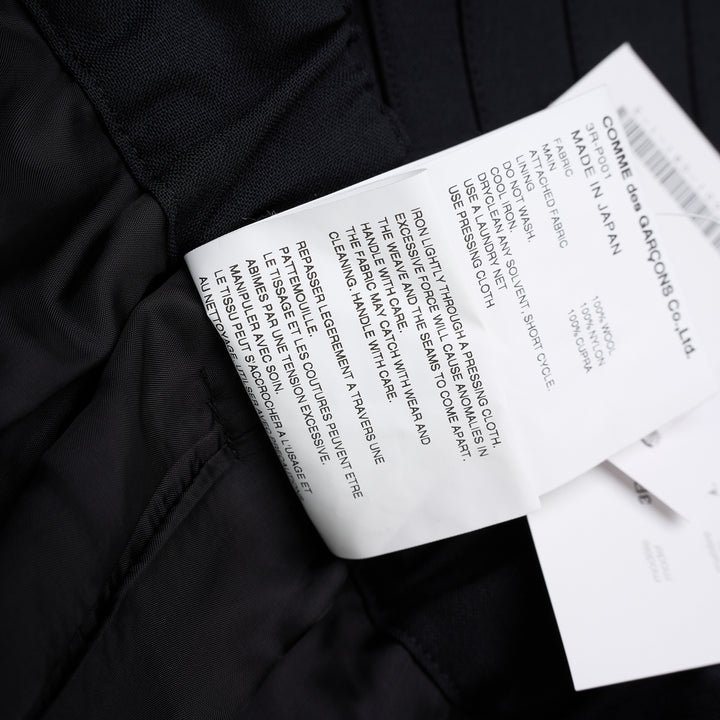Noir Kei Ninomiya black wool tropical shorts with a stitched flared hem and layered black nylon tulle ruffles - view 8