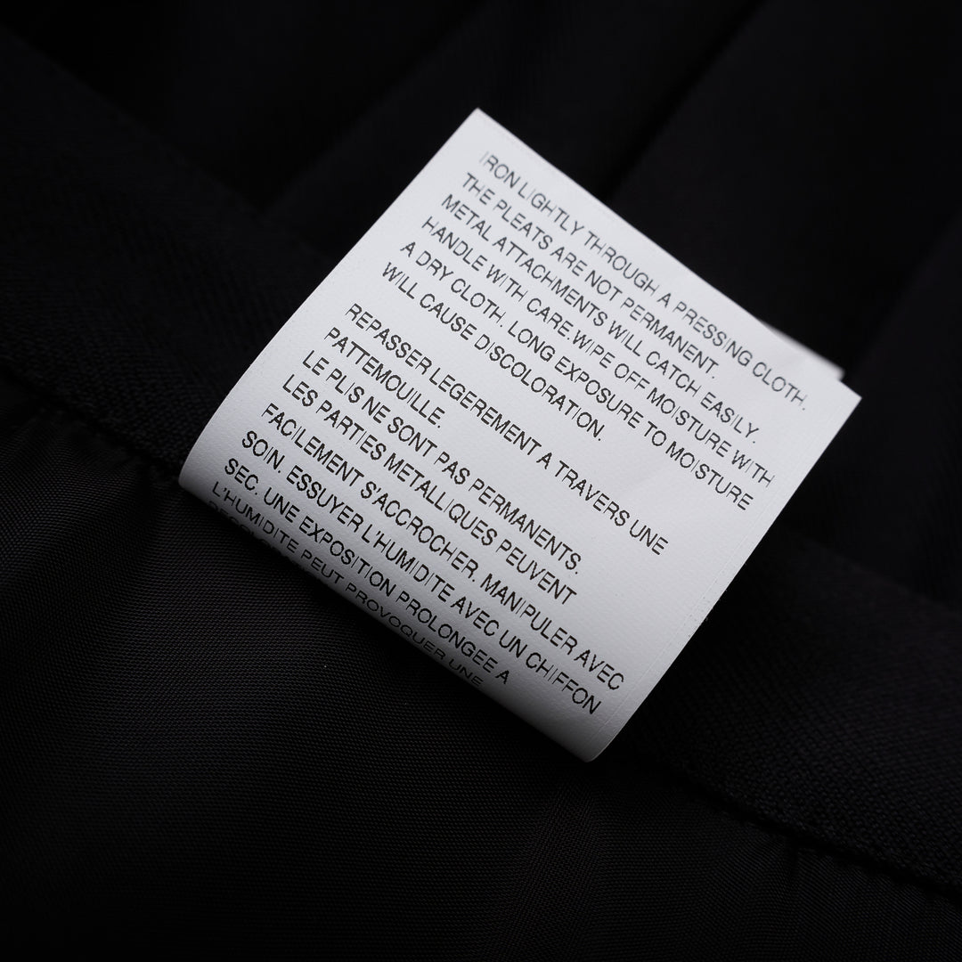 Noir Kei Ninomiya black pleated vest in wool polyester gabardine with grommet-studded buckle straps and layered peplum - view 6