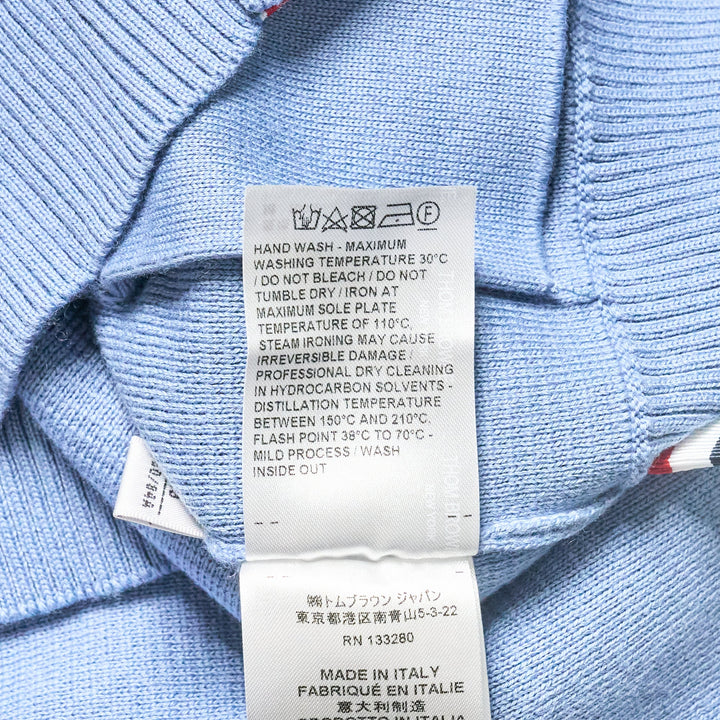 Thom Browne sky blue Milano stitch cardigan with four white bar stripes on the sleeve, V-neck, button front, and patch pockets