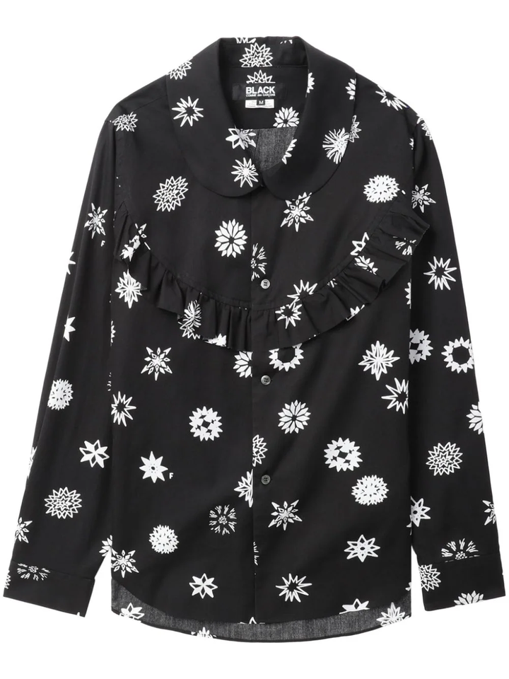 Comme des Garçons BLACK Filip Pagowski print long-sleeve blouse in black with white snowflake motifs, ruffle bib detail, and peter pan collar