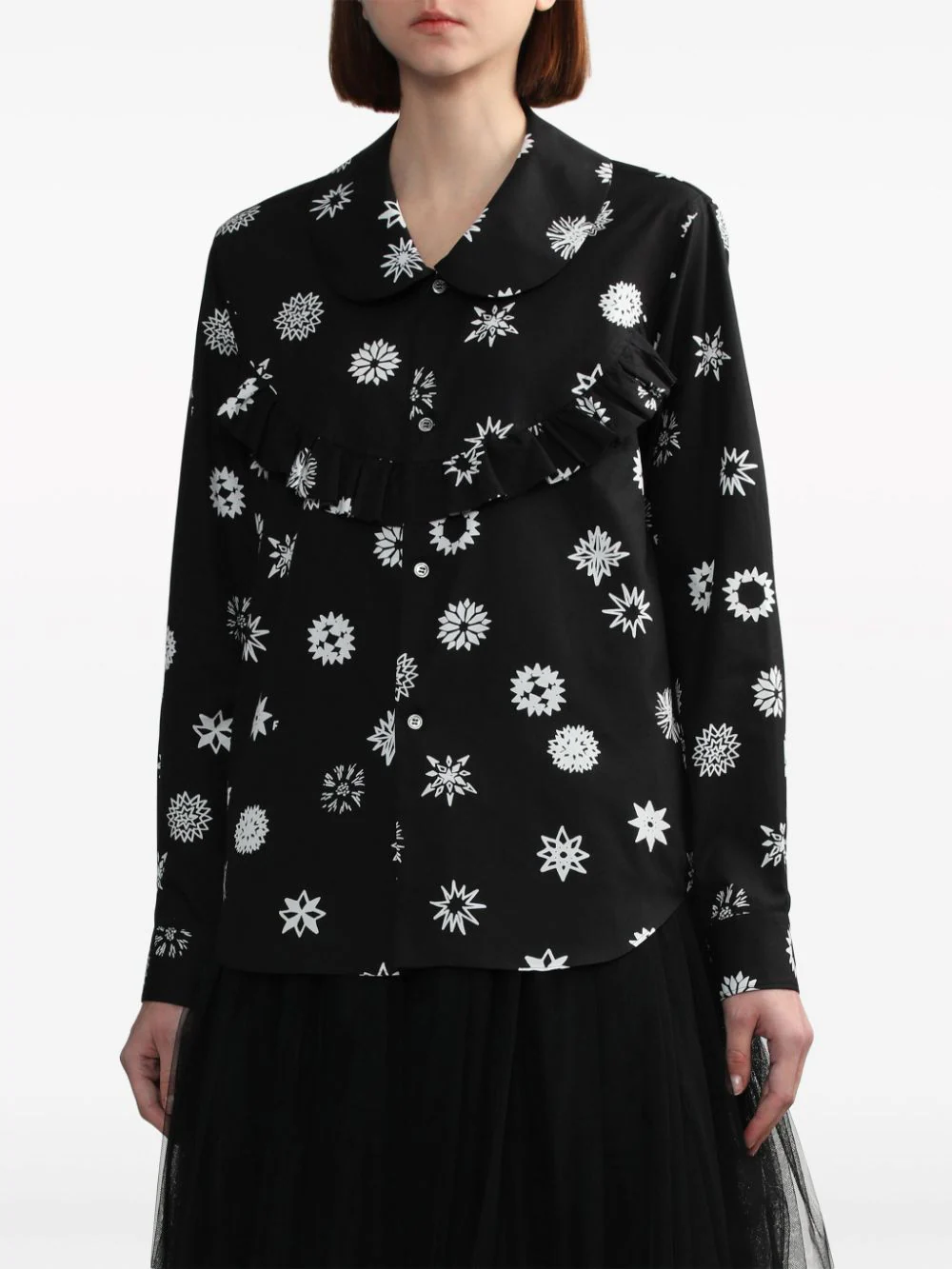 Comme des Garçons BLACK Filip Pagowski print long-sleeve blouse in black with white snowflake motifs, ruffle bib detail, and peter pan collar