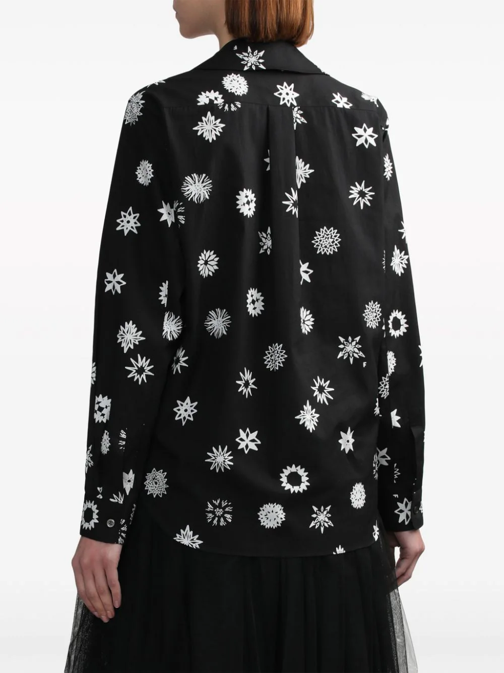 Comme des Garçons BLACK Filip Pagowski print long-sleeve blouse in black with white snowflake motifs, ruffle bib detail, and peter pan collar