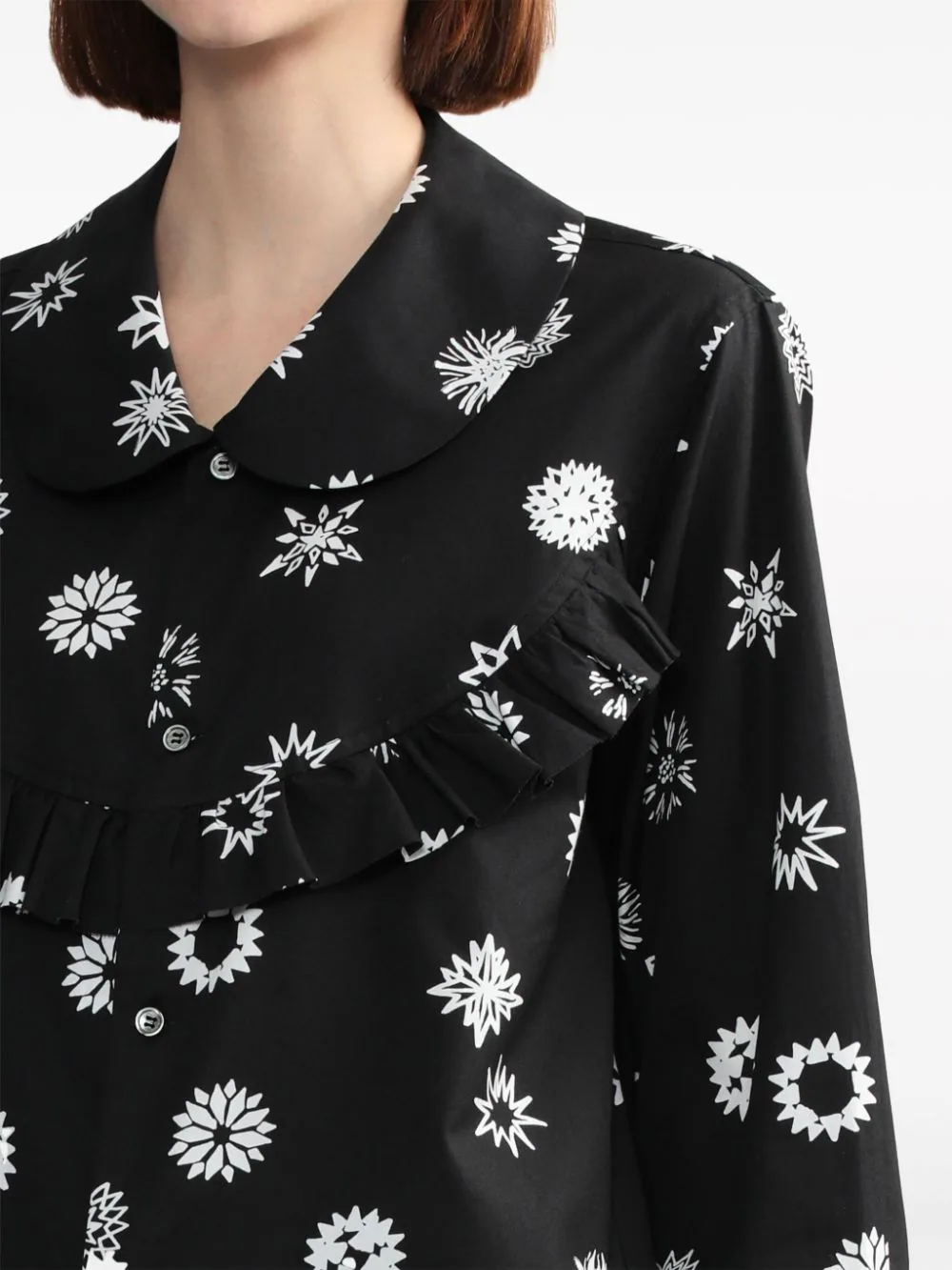 Comme des Garçons BLACK Filip Pagowski print long-sleeve blouse in black with white snowflake motifs, ruffle bib detail, and peter pan collar