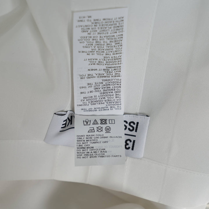 132 5. Issey Miyake white origami pleated standard jacket with geometric angular panels and ruffled three-quarter sleeves, front view