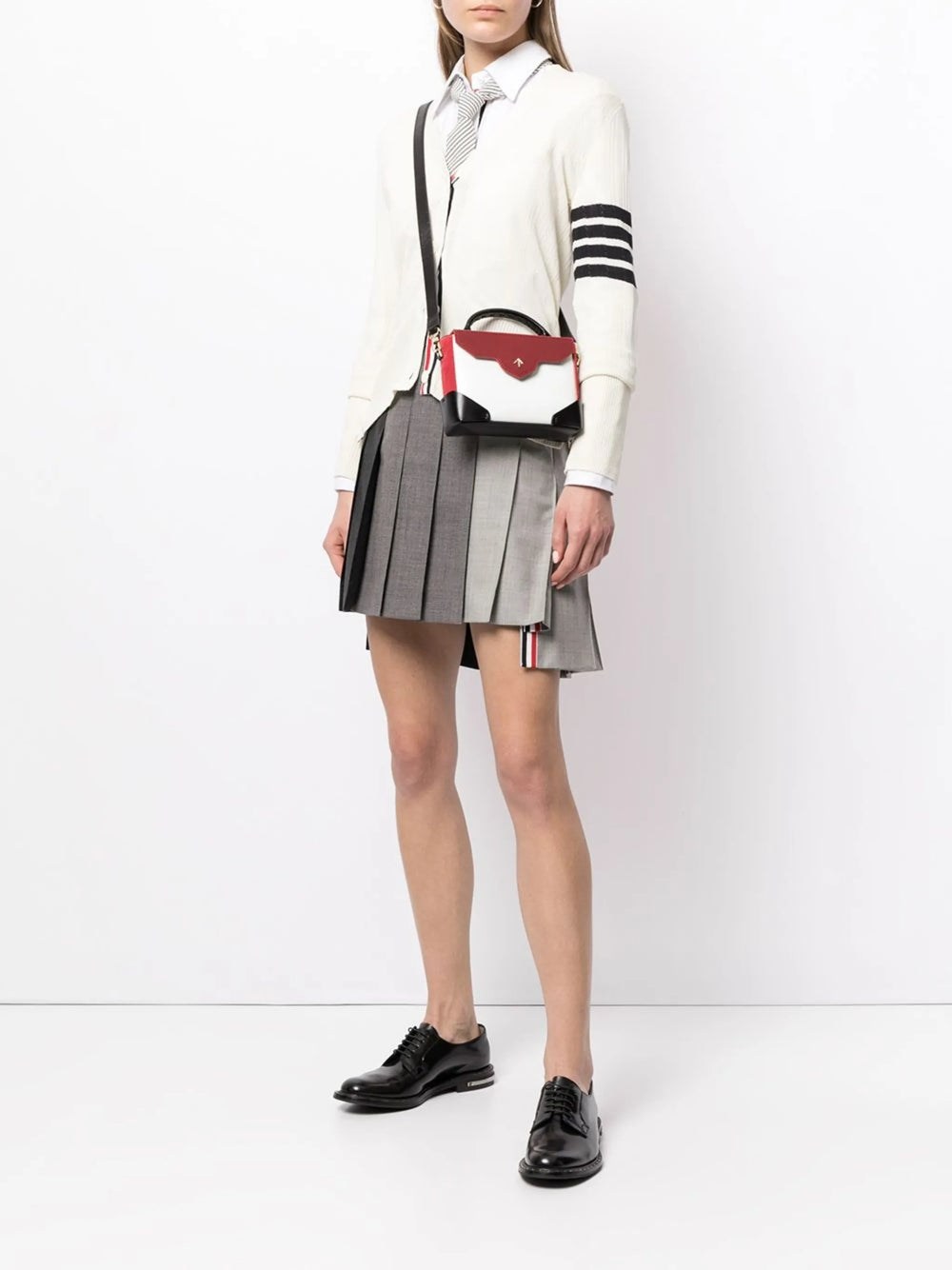 Thom Browne tonal grey colorblock dropped back pleated mini skirt with signature red white and blue stripe tab at hem