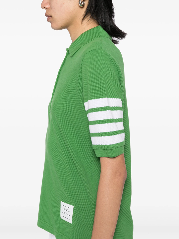 Thom Browne light blue short sleeve piqué polo shirt with white 4-bar stripe on sleeve and tri-colour hem trim, made in Italy