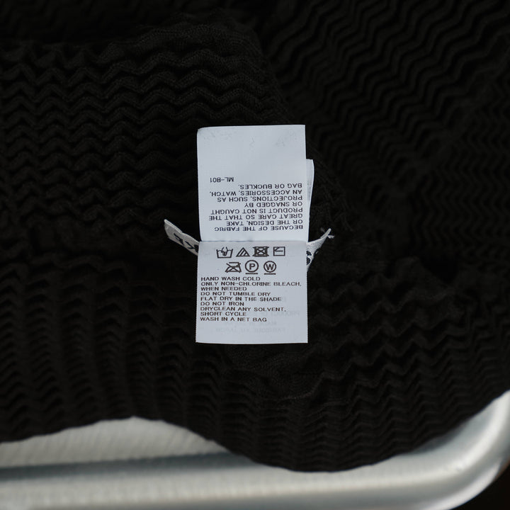 Issey Miyake Spongy Zip-Up Cardigan in black with three-dimensional waffle knit texture, full-length centre zip, and high funnel neck